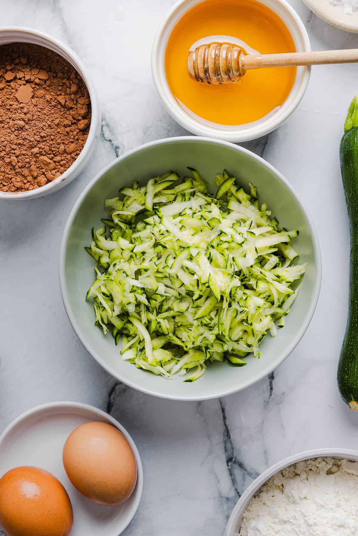 These Fudgy Zucchini Brownies are deliciously moist with a rich chocolate taste loaded with shredded zucchini and made healthier with zero butter or refined sugar! One of our family's favorite summer desserts!