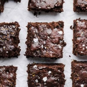 These Fudgy Zucchini Brownies are deliciously moist with a rich chocolate taste loaded with shredded zucchini and made healthier with zero butter or refined sugar! One of our family's favorite summer desserts!