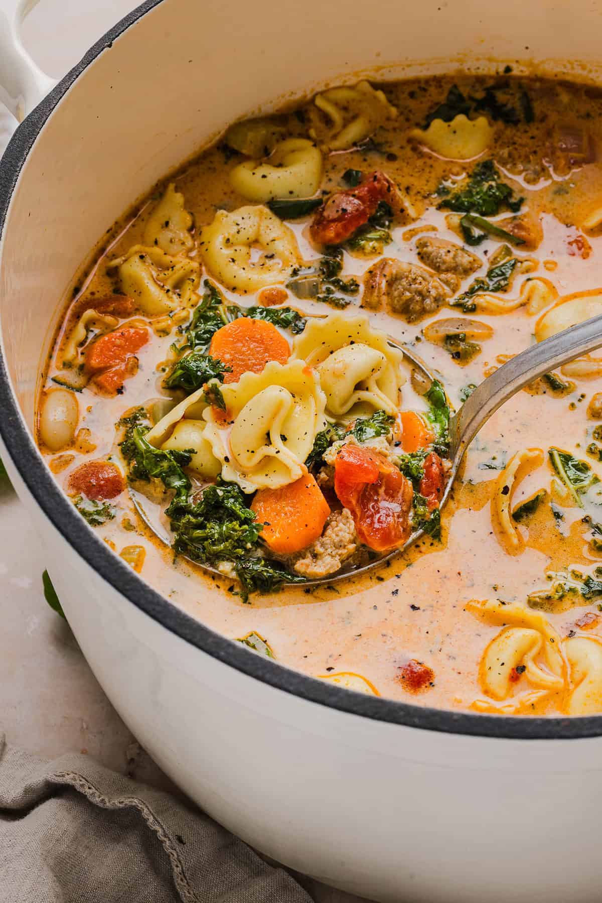 This Creamy Tortellini Soup is cozy, comforting and made with tender cheese tortellini, fresh veggies, herbs and a rich creamy broth. The perfect one pot meal that is both flavorful and satisfying!
