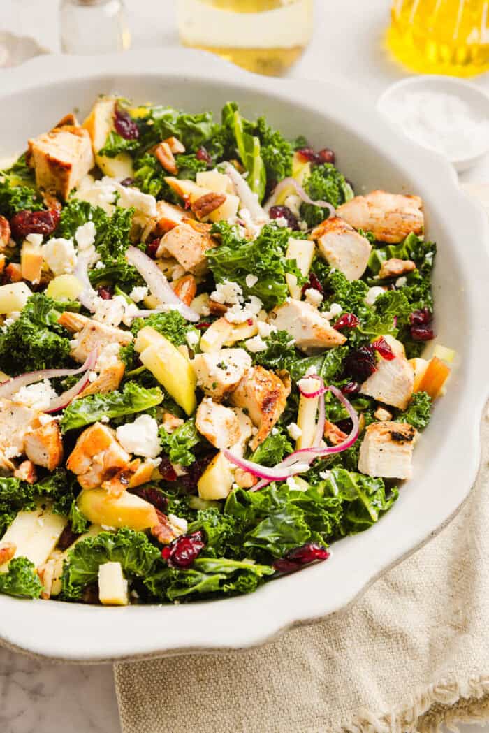 This fresh and flavorful Harvest Chopped Chicken Salad is made with leafy kale, tender juicy chicken, chopped apples and crunchy pecans all tossed with a maple dijon dressing! This salad is hearty enough for dinner and light enough for lunch!