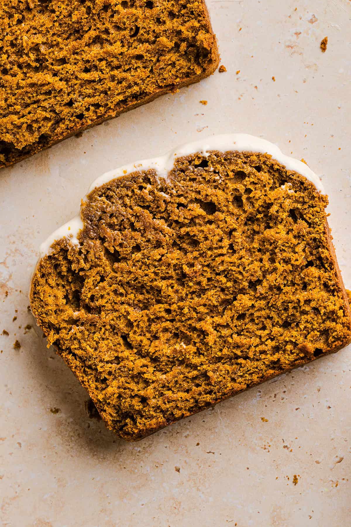 The BEST Healthy Pumpkin Bread that is moist, loaded with pumpkin flavor and made without any butter or refined sugar! Topped with a delicious maple cream cheese glaze for the perfect fall treat this season!